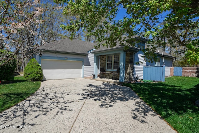 single story home with a garage, fence, driveway, and a front lawn