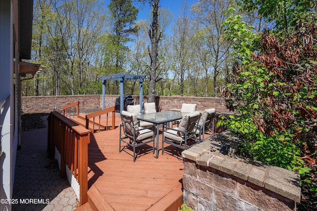 deck with a pergola and outdoor dining space