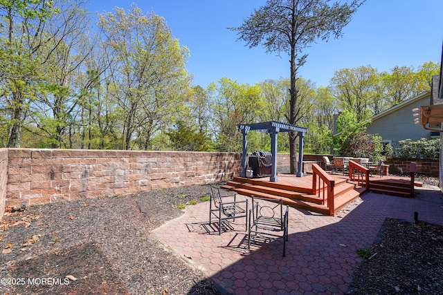 exterior space featuring a patio area, fence, a pergola, and a deck