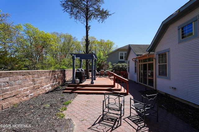 view of patio with fence and a deck