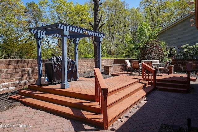 wooden deck featuring area for grilling, a pergola, fence, and outdoor dining space