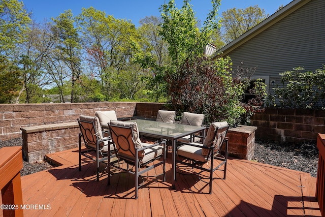 wooden deck featuring outdoor dining area