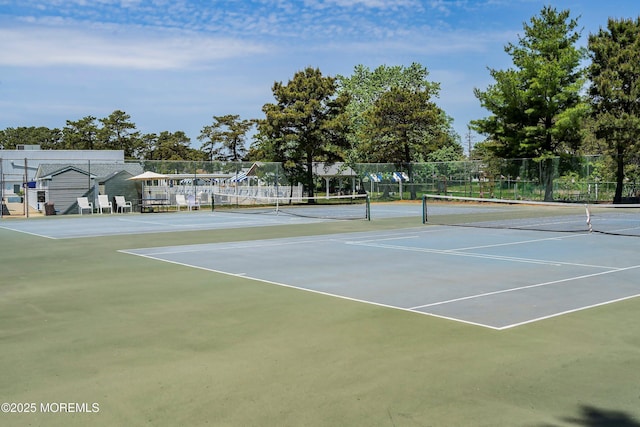 view of tennis court with fence