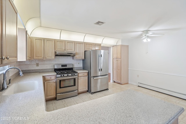 kitchen featuring a sink, appliances with stainless steel finishes, under cabinet range hood, and light brown cabinets