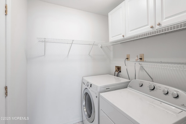 laundry room with cabinet space and washing machine and dryer