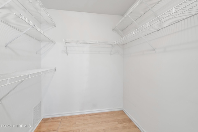 spacious closet with visible vents and light wood-style flooring