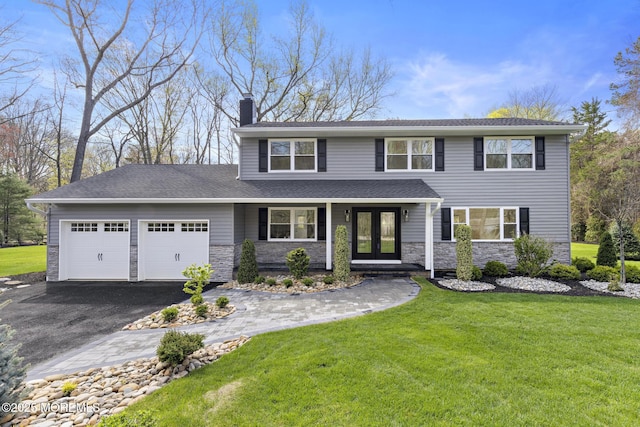 traditional-style home with a chimney, an attached garage, aphalt driveway, and stone siding