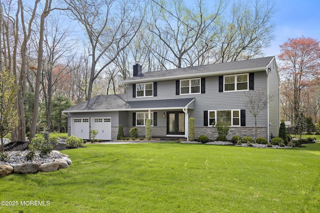 view of front of house with a garage, a front yard, stone siding, french doors, and a chimney