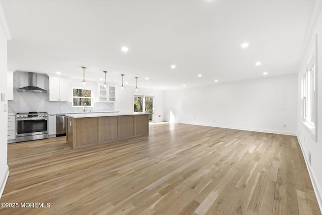 unfurnished living room featuring crown molding, visible vents, baseboards, recessed lighting, and light wood-style flooring