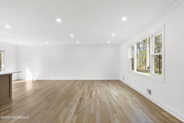 unfurnished living room featuring crown molding, recessed lighting, visible vents, and light wood finished floors