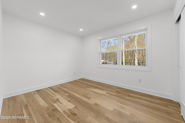 unfurnished room featuring baseboards, recessed lighting, and light wood-type flooring