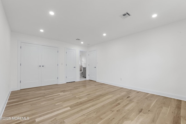 spare room with recessed lighting, baseboards, visible vents, and light wood finished floors