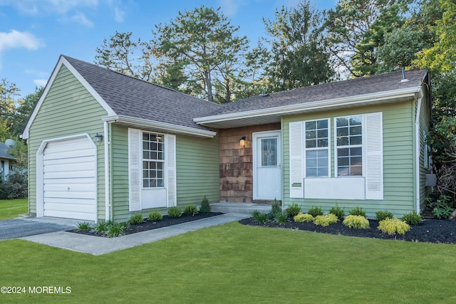 single story home with aphalt driveway, a shingled roof, and a front yard