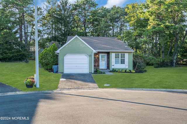 single story home with roof with shingles, a front lawn, driveway, and an attached garage