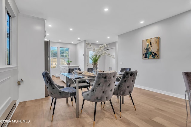 dining space with light wood-type flooring, recessed lighting, a baseboard heating unit, and baseboards