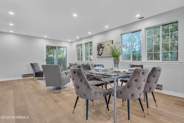 dining area featuring baseboard heating, visible vents, light wood-style floors, and recessed lighting