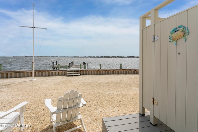 view of yard with a water view and a boat dock