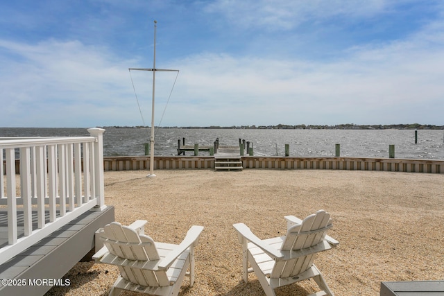 view of yard with a boat dock and a water view