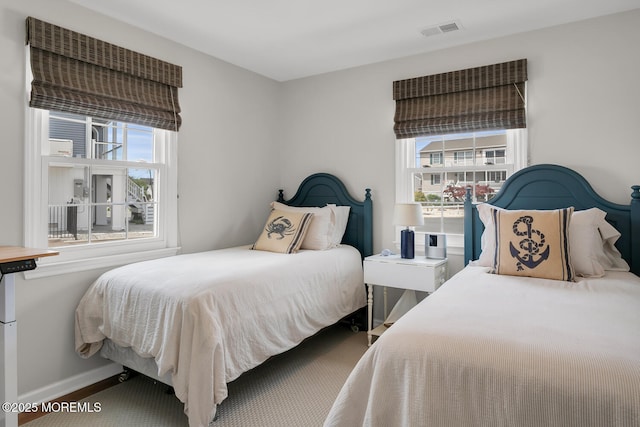 bedroom featuring baseboards and visible vents