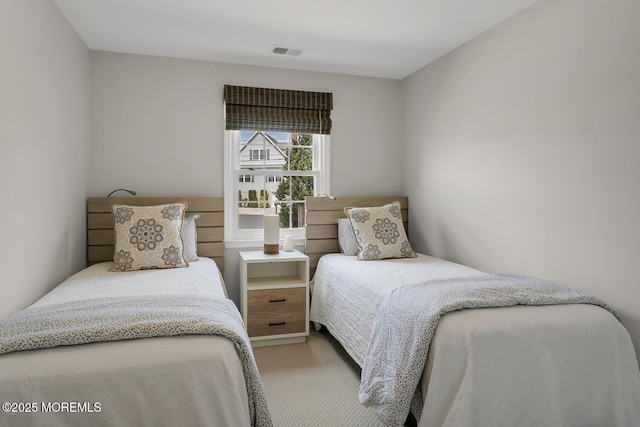 carpeted bedroom with visible vents