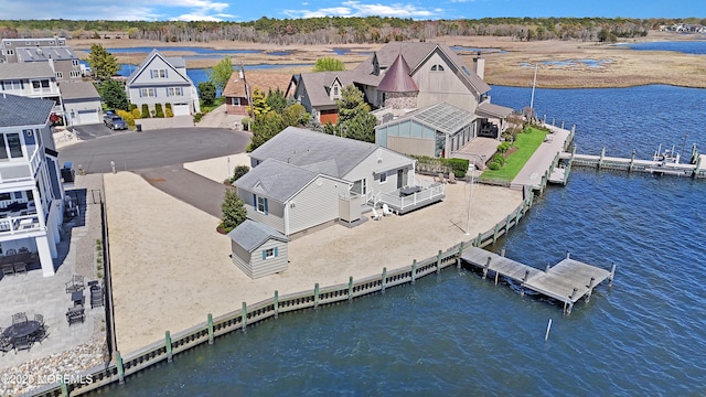 drone / aerial view with a water view and a residential view