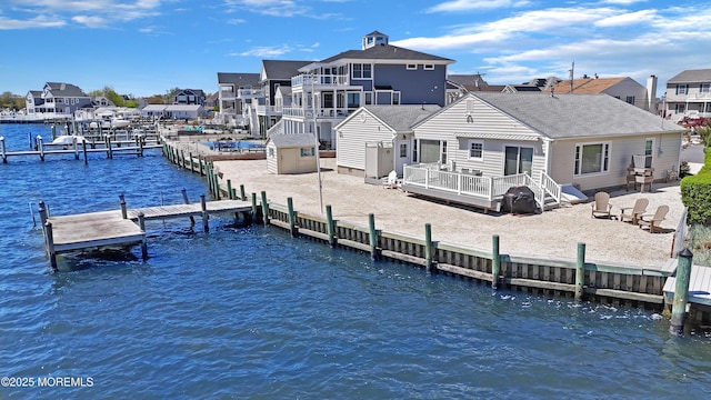 dock area with a residential view and a deck with water view