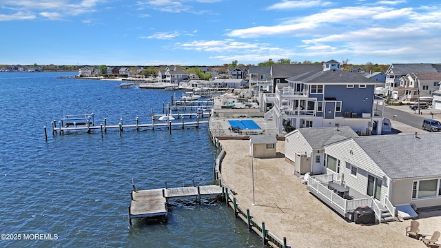 view of dock featuring a water view and a residential view