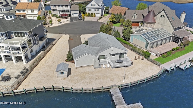 drone / aerial view with a residential view and a water view