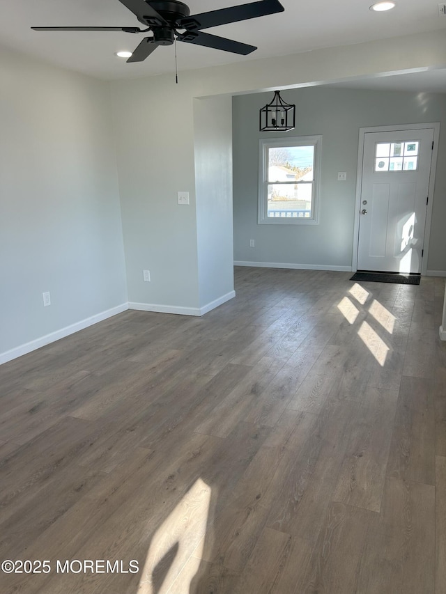 unfurnished living room with recessed lighting, a ceiling fan, baseboards, and dark wood finished floors