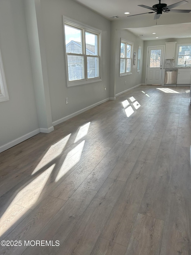 empty room featuring recessed lighting, wood-type flooring, baseboards, visible vents, and a ceiling fan