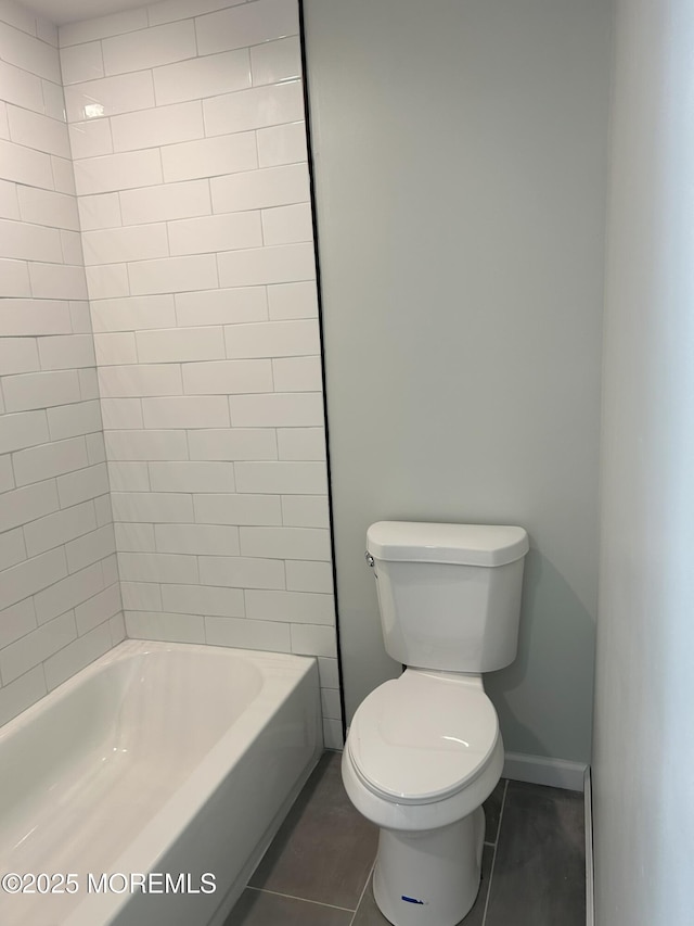 bathroom with tile patterned floors, toilet, and baseboards