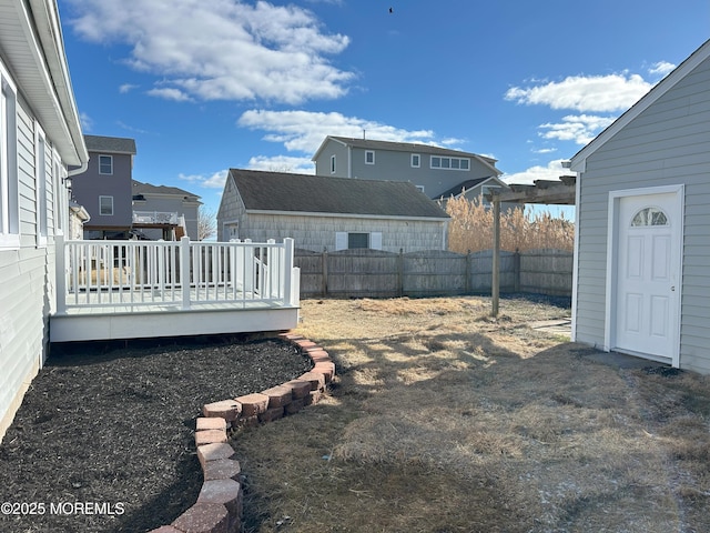 view of yard featuring a deck, a fenced backyard, and a residential view