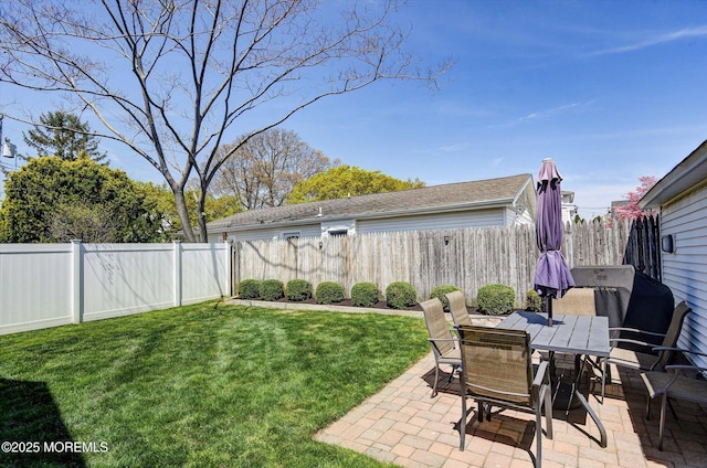 view of yard featuring outdoor dining space, a patio, and a fenced backyard