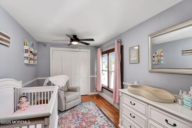 bedroom with a closet, ceiling fan, and light wood-style flooring