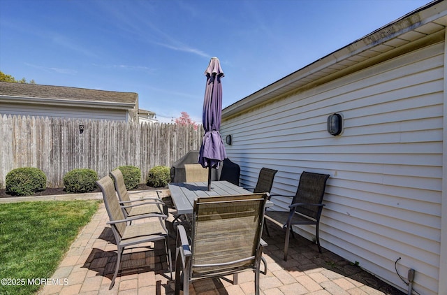view of patio / terrace featuring fence and outdoor dining area