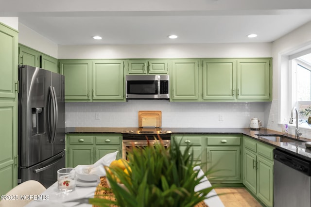 31 Mulberry Ct Unit B, Brielle, NJ 08730 - kitchen featuring a sink, green cabinetry, appliances with stainless steel finishes, and backsplash