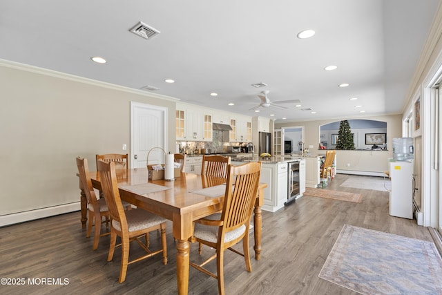 1582 Beaver Hollow Dr, Toms River, NJ 08755 - dining area featuring wine cooler, crown molding, recessed lighting, light wood-style floors, and baseboard heating