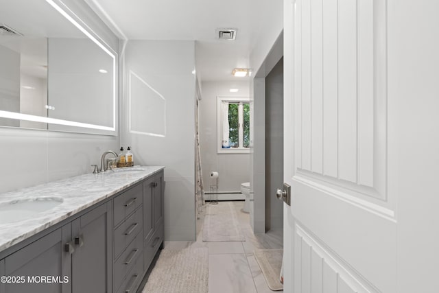 1582 Beaver Hollow Dr, Toms River, NJ 08755 - bathroom with a baseboard heating unit, marble finish floors, toilet, double vanity, and a shower