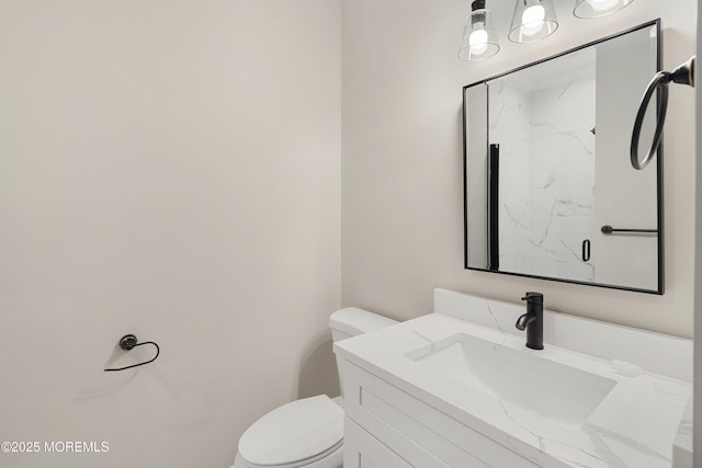 bathroom featuring toilet and vanity