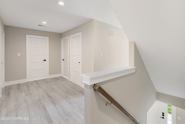 stairway with visible vents, recessed lighting, baseboards, and wood finished floors