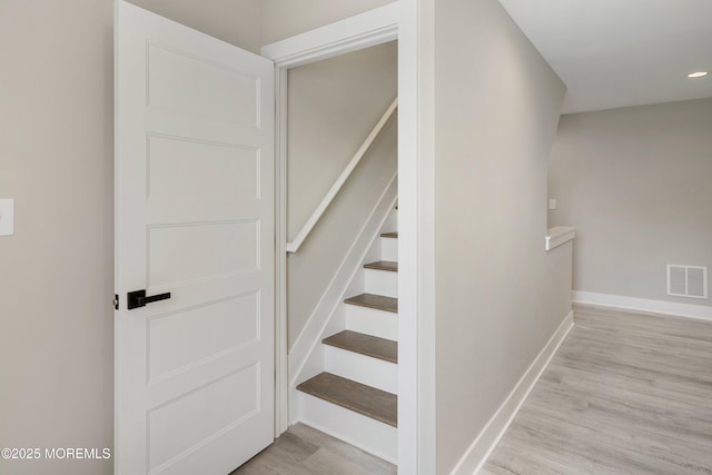 stairs featuring recessed lighting, baseboards, visible vents, and wood finished floors