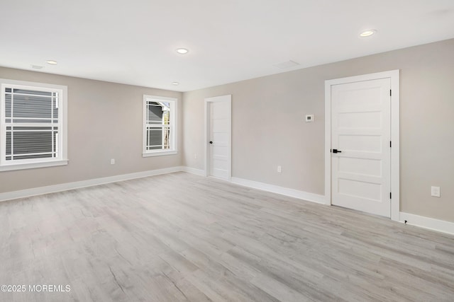 unfurnished room with recessed lighting, baseboards, and light wood finished floors