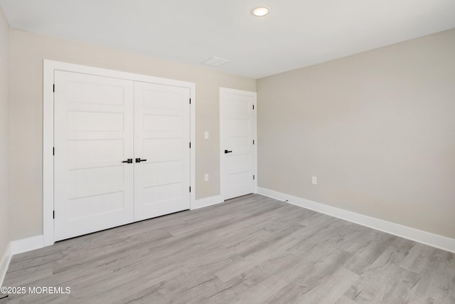 unfurnished bedroom featuring baseboards, recessed lighting, and light wood-type flooring