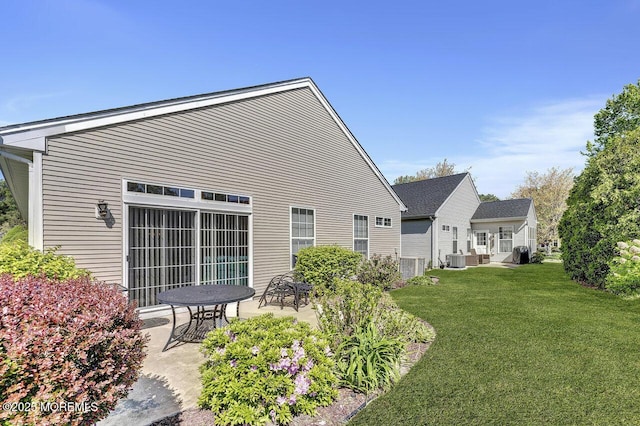 back of house with a lawn, central AC, and a patio area