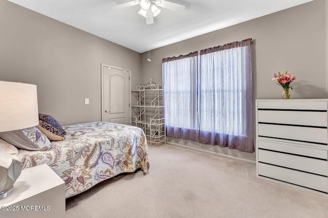 bedroom featuring a ceiling fan and carpet