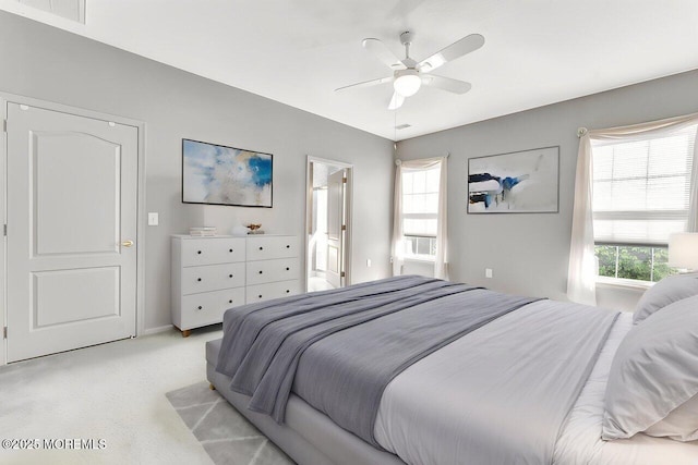 bedroom with visible vents, ceiling fan, and light colored carpet