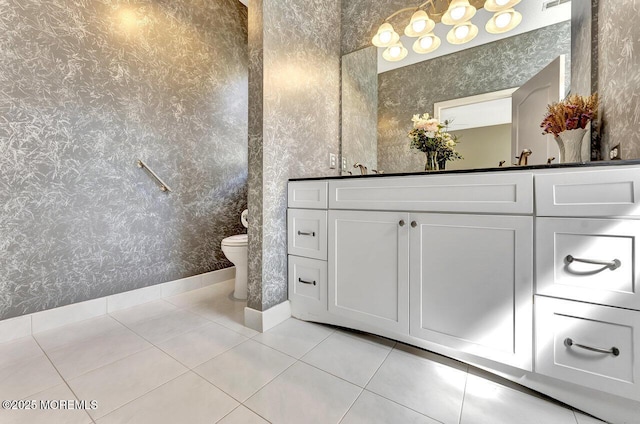 bathroom featuring toilet, wallpapered walls, tile patterned floors, and vanity