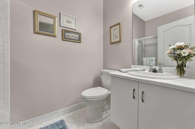 bathroom featuring visible vents, vanity, toilet, tile patterned floors, and a stall shower