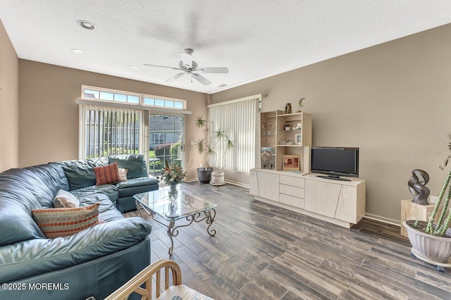 living area with baseboards, dark wood-type flooring, recessed lighting, a textured ceiling, and a ceiling fan
