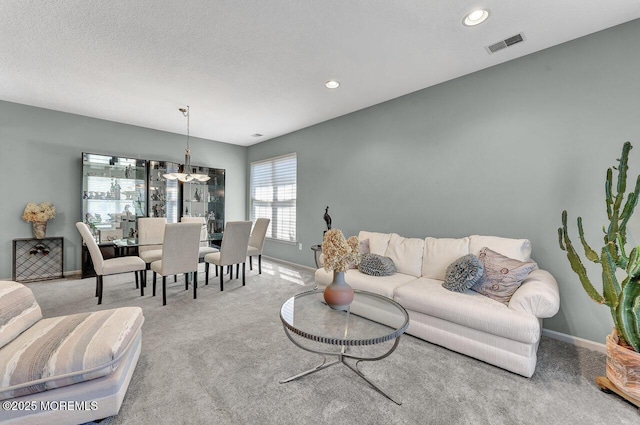 carpeted living room with recessed lighting, baseboards, a chandelier, and visible vents